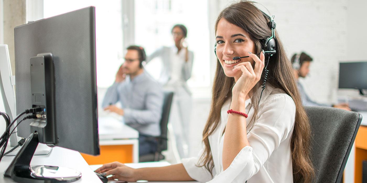 Woman on phone in front of computer