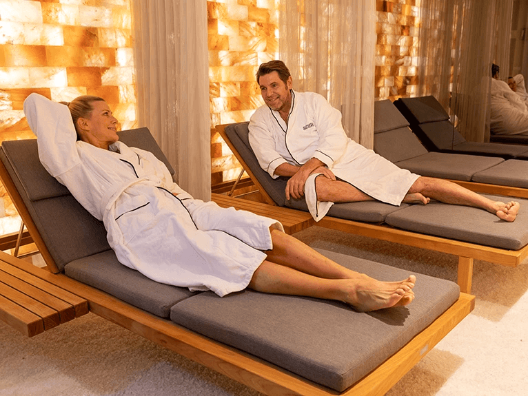 A man and woman lying on loungers in the Salt Therapy Lounge on a Scenic cruise ship. 