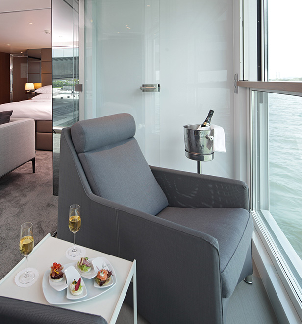 The Scenic Sun Lounge area in the Royal Panorama Suite, set with canapes and champagne on the table. 