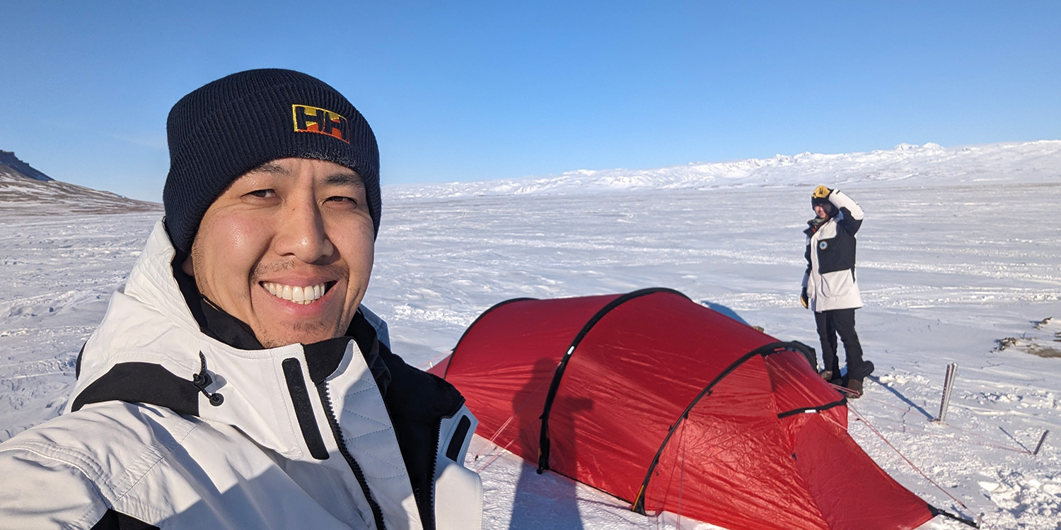 Bill Kwok with Dr Scott Pallett in the background in Antarctica