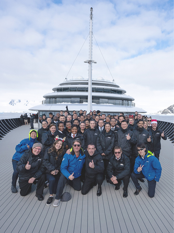 group shot of the crew on the deck of the ultra-luxury cruise ship "Scenic Eclipse II" in Antarctica