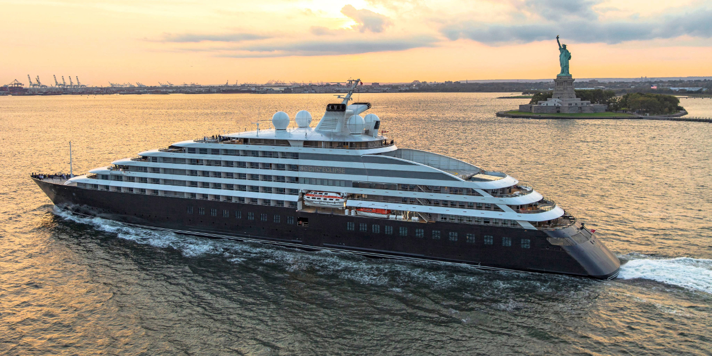 Large ship sailing past the statue of Liberty in New York