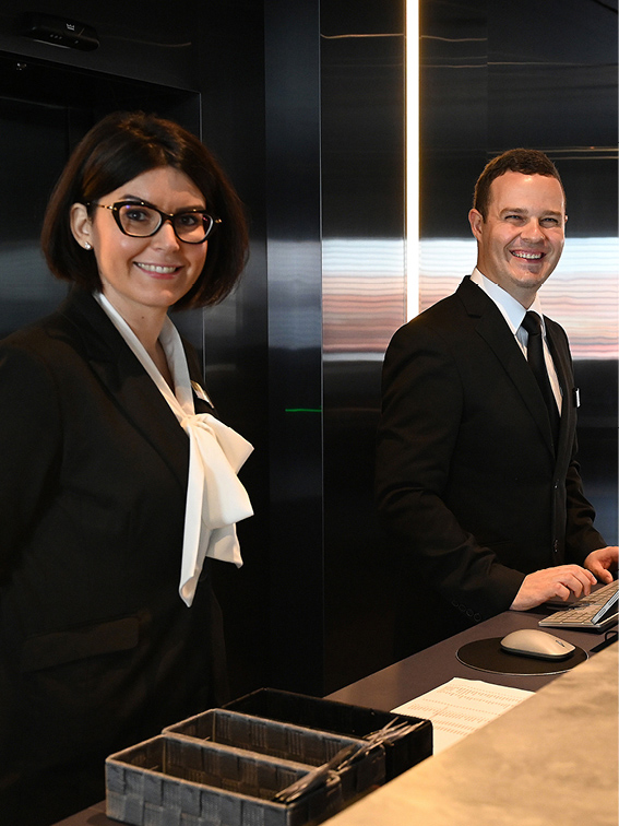 Man and women standing at the front desk